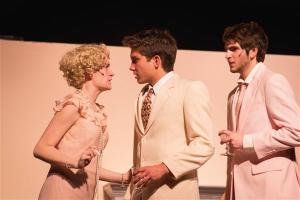 Daisy Buchanan (Erin Powell) and Tom Buchanan (Dylan Hubbs) wrapped in a mix of emotions as Gatsby watches (Jason Friedman) 