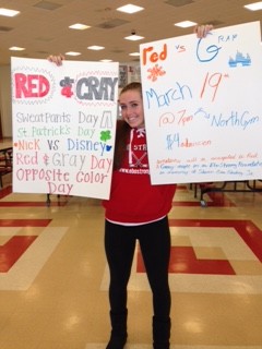 Senior Grey Team Captain Jamie Moore holds up posters for Red and Grey Night