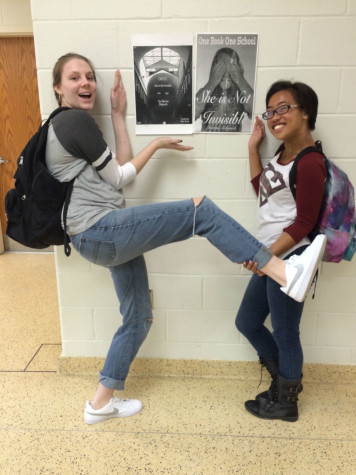 (From left to right) Robyn Kiernan ('17) and Lauren Palma ('17) stand next two of the several OBOS posters around the school.