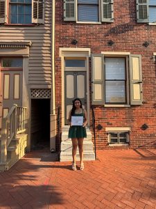 Isabel Petta in front of Walt Whitman's home, where the award ceremony took place.  